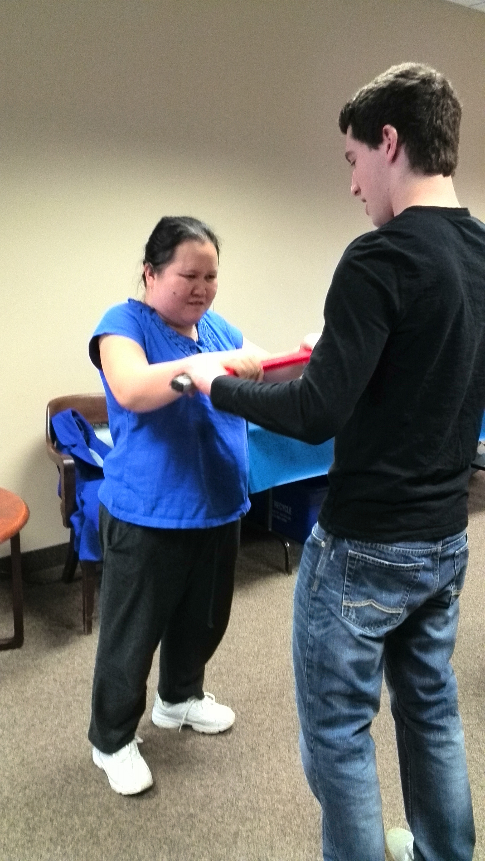 Trainer helping the member to exercise