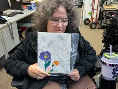 KWA Member Kerrie with her painting from Arts event at our office